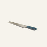 A bread knife with a serrated blade and a dark green handle is shown on a plain light background.