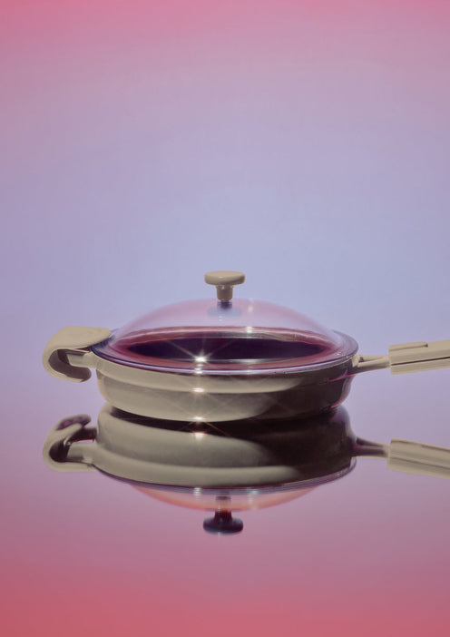 beige cast iron always pan with pink background