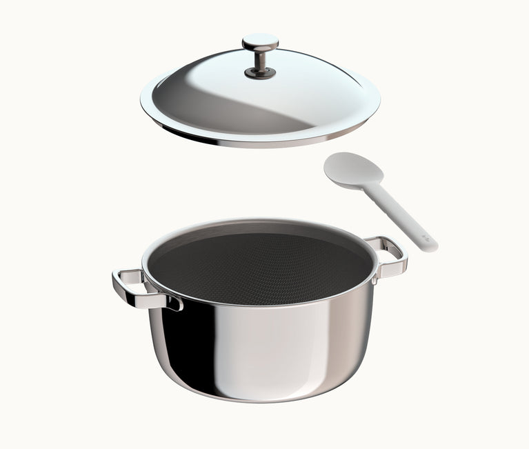 Stainless steel cooking pot with a detached lid and a white stirring spoon.