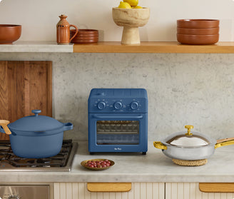 blue perfect pot on stove, blue wonder oven and gold titanium always pan pro on counter