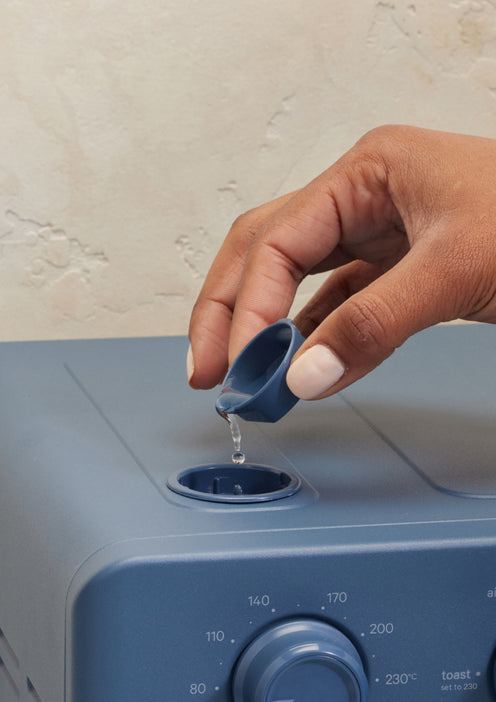 pouring water into steam component
