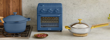 blue perfect pot on stove, blue wonder oven and gold titanium mini always pan on counter