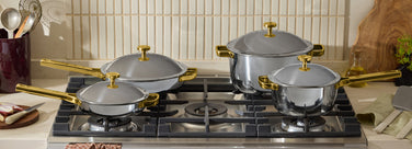 gold titanium always pan, mini always pan, perfect pot and mini perfect pot on stove