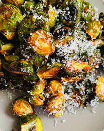 Roasted Brussels sprouts topped with grated cheese.