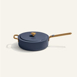 Blue ceramic cookware with gold handles on a white background