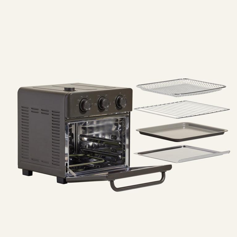 Black toaster oven with open door and racks on a white background
