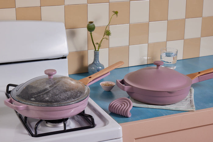 Two lavender pans on a stovetop 