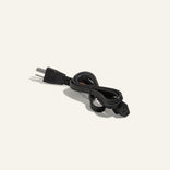 A coiled black power cord with a two-prong plug on one end and a rectangular connector on the other, set against a plain white background.