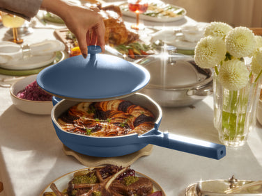 Blue pan with food inside on a decorated dinner table