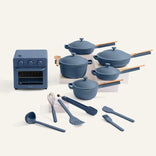 Set of blue cookware and white plates on a white background