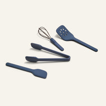 Mini Utensil Essentials: set of four sturdy silicone tools—spatula, tongs, metal wire whisk, and slotted turner—arranged on a light background.