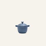 The Petite Perfect Pot, a blue nonstick pot with two handles, sits on a light background—ideal for personal servings and made from non-toxic materials.