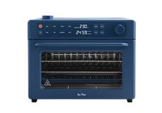 Blue Our Place countertop oven with a digital display showing 230 degrees and a 24:59 timer.