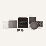 A black oven and accessories on a white background