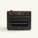 The Wonder Oven Pro, in black, features a digital display for temperature and time, top buttons and dials, plus multiple wire racks inside on a plain background.