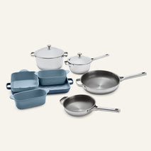 Titanium Pro Cookware + Bakeware Set 2.0 containing two stainless steel pots with lids, two stainless steel frying pans, and three blue ceramic bakeware dishes.