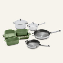 Titanium Pro Cookware + Bakeware Set 2.0 featuring stainless steel pots and pans with lids, green ceramic bakeware dishes, and a checkered tray.