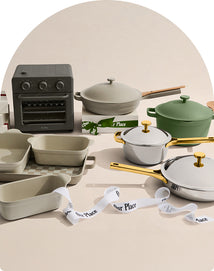 Kitchenware items including pots, pans, and a small oven on a neutral background with 'Our Place' branding.