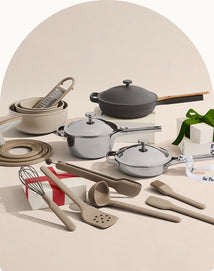 Set of cookware and kitchen utensils on a neutral background