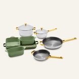Titanium Pro Cookware + Bakeware Set 2.0 featuring high-performance stainless steel pots and pans with gold-toned handles, green ceramic bakeware, and a matching checkered tray.