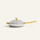Titanium Always Pan Pro 26 cm 2.0 light gray stainless steel frying pan with a matching lid, gold-tone handle, and gold-tone side helper handle.