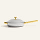 A silver-colored Titanium Always Pan Pro 32 cm frying pan with a lid and gold-tone handles.