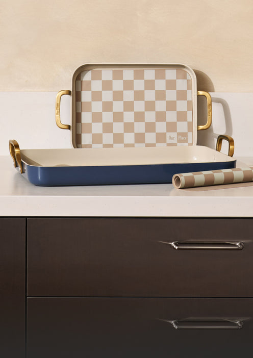 Set of trays with checkered top and blue base on a kitchen counter