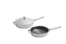 Two stainless steel pans with helper handles, one with a white lid and one without.