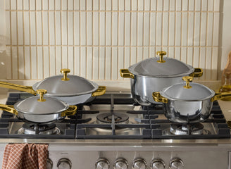gold titanium always pan pro, perfect pot pro, mini always pan pro and mini perfect pot pro on stove