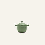 The Petite Perfect Pot, a green nonstick pot with two side handles and a fitted lid, ideal for personal servings, is set against a plain off-white background.