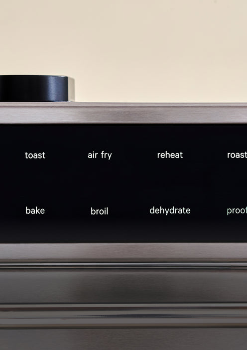 Digital control panel of a kitchen appliance with labels for toast, air fry, reheat, roast, bake, broil, dehydrate, and proof.