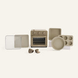 Cream oven and accessories on a white background