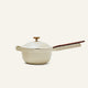 Presenting the Ceramic Nonstick Perfect Pot 2.5 L: a cream-colored saucepan with a lid and a long straight handle featuring an elegant wooden grip, shown against a plain light background. This multifunctional pot is thoughtfully designed for your convenience, offering a toxin-free, nonstick cooking experience.